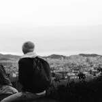Two people looking over a city skyline