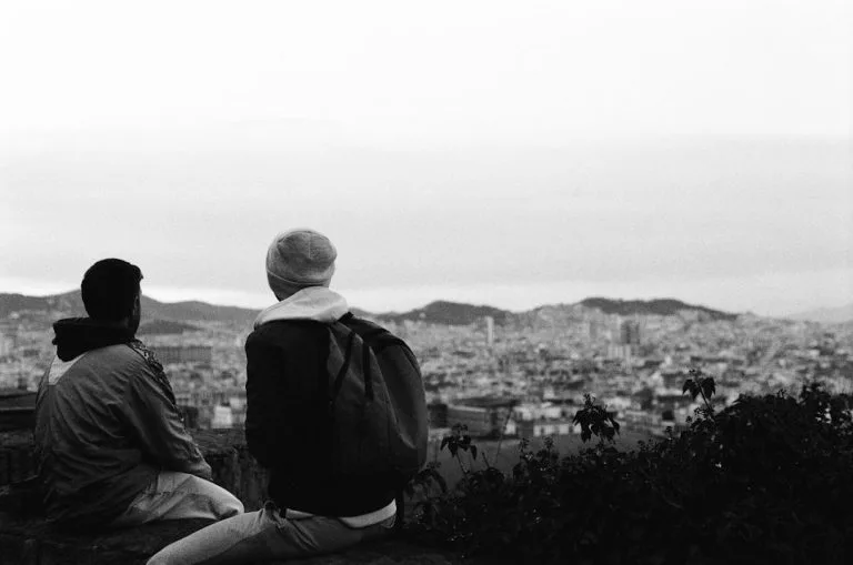 Two people looking over a city skyline