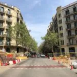 a city street with a construction zone in the foreground
