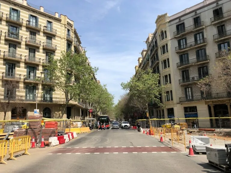 a city street with a construction zone in the foreground