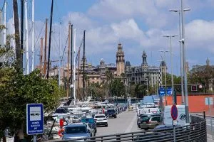 City street with cars, marina, and historic architecture