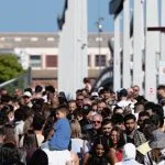 A large group of people walking down a street