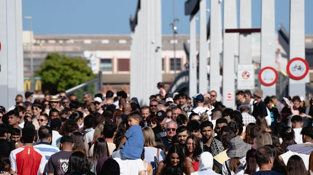 A large group of people walking down a street