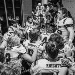 Football team huddles in locker room before game