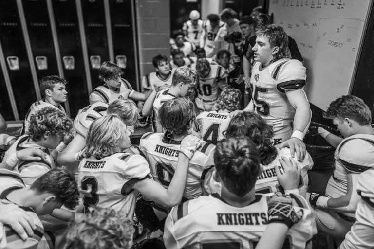 Football team huddles in locker room before game