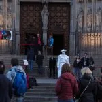 A group of people standing in front of a building