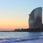glass building near sea during sunset