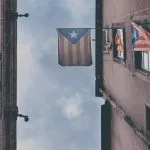 blue white and red flag on black steel pole during daytime