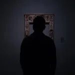 silhouette of person facing an empty photo frame