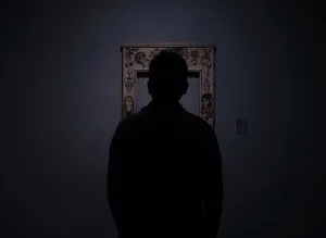silhouette of person facing an empty photo frame