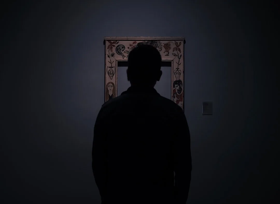 silhouette of person facing an empty photo frame