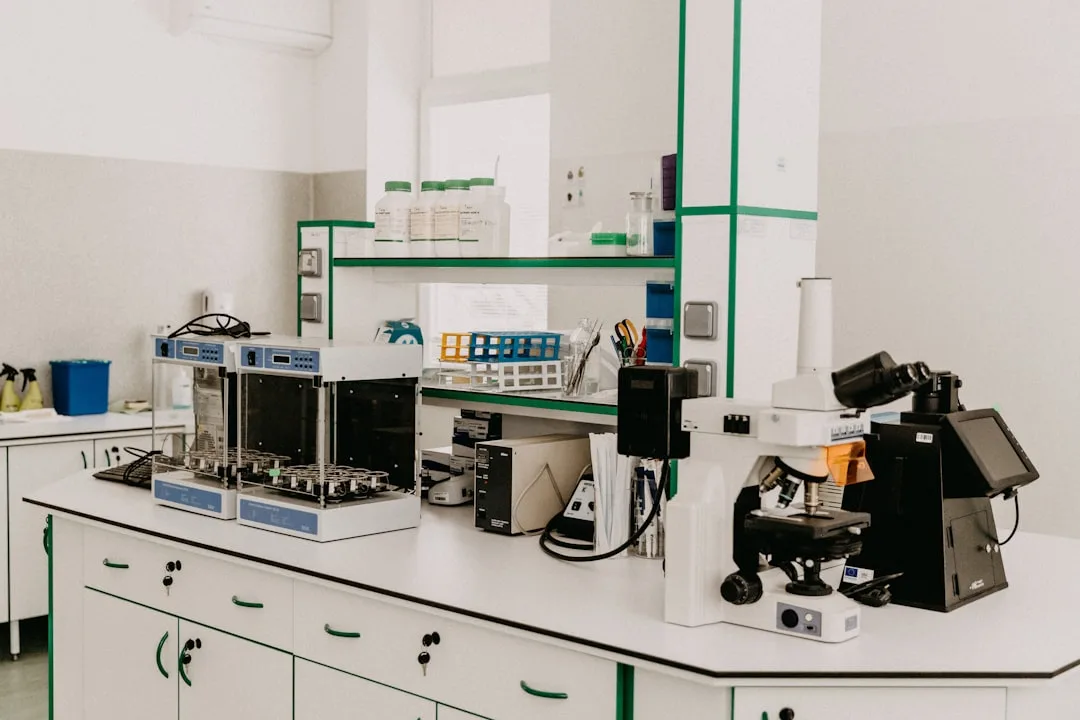 A laboratory workbench with a microscope and analytical equipment in a bright room