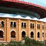 a large building with a red roof and a clock on it