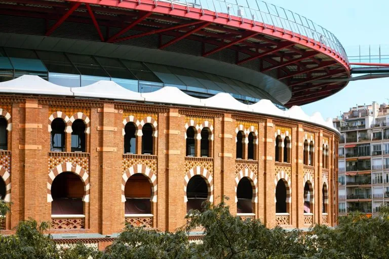 a large building with a red roof and a clock on it