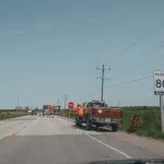 Road construction worker with stop sign and truck