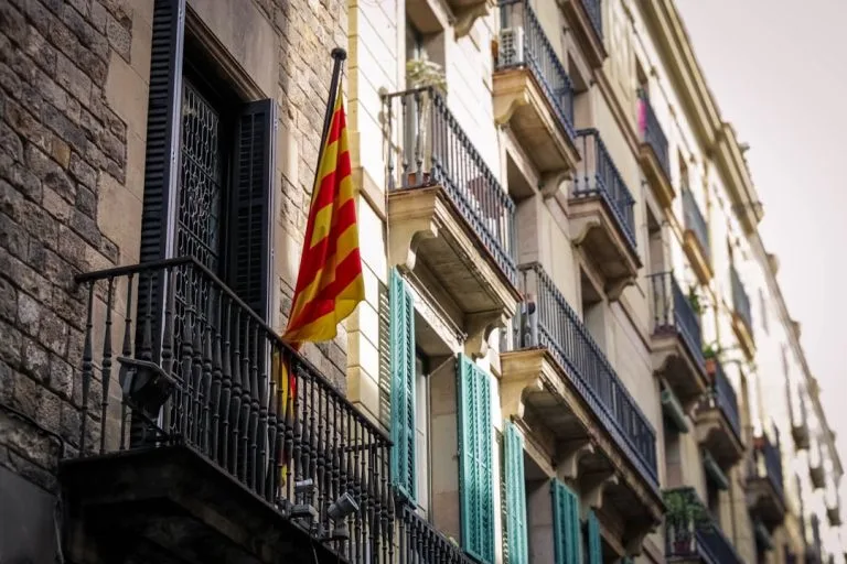 Catalan flag hanging from a balcony on a building