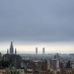 Overcast city skyline with prominent cathedral and distant towers