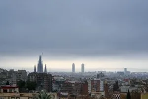 Overcast city skyline with prominent cathedral and distant towers