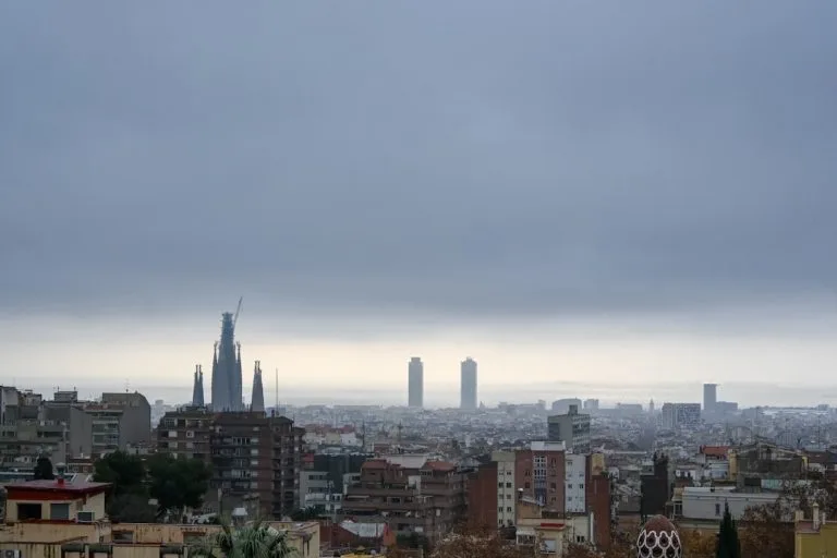 Overcast city skyline with prominent cathedral and distant towers