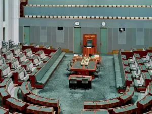 Empty parliamentary chamber with rows of seats